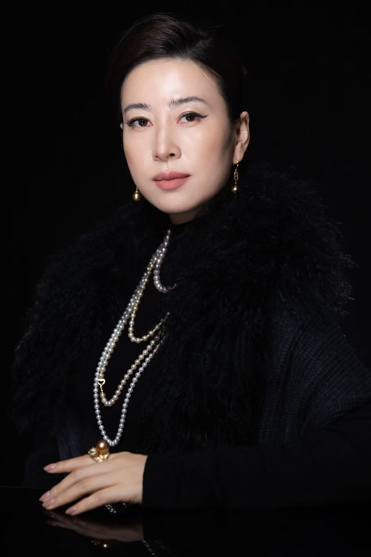 M&T Jewelry founder Meili Lu wearing layered pearl necklaces