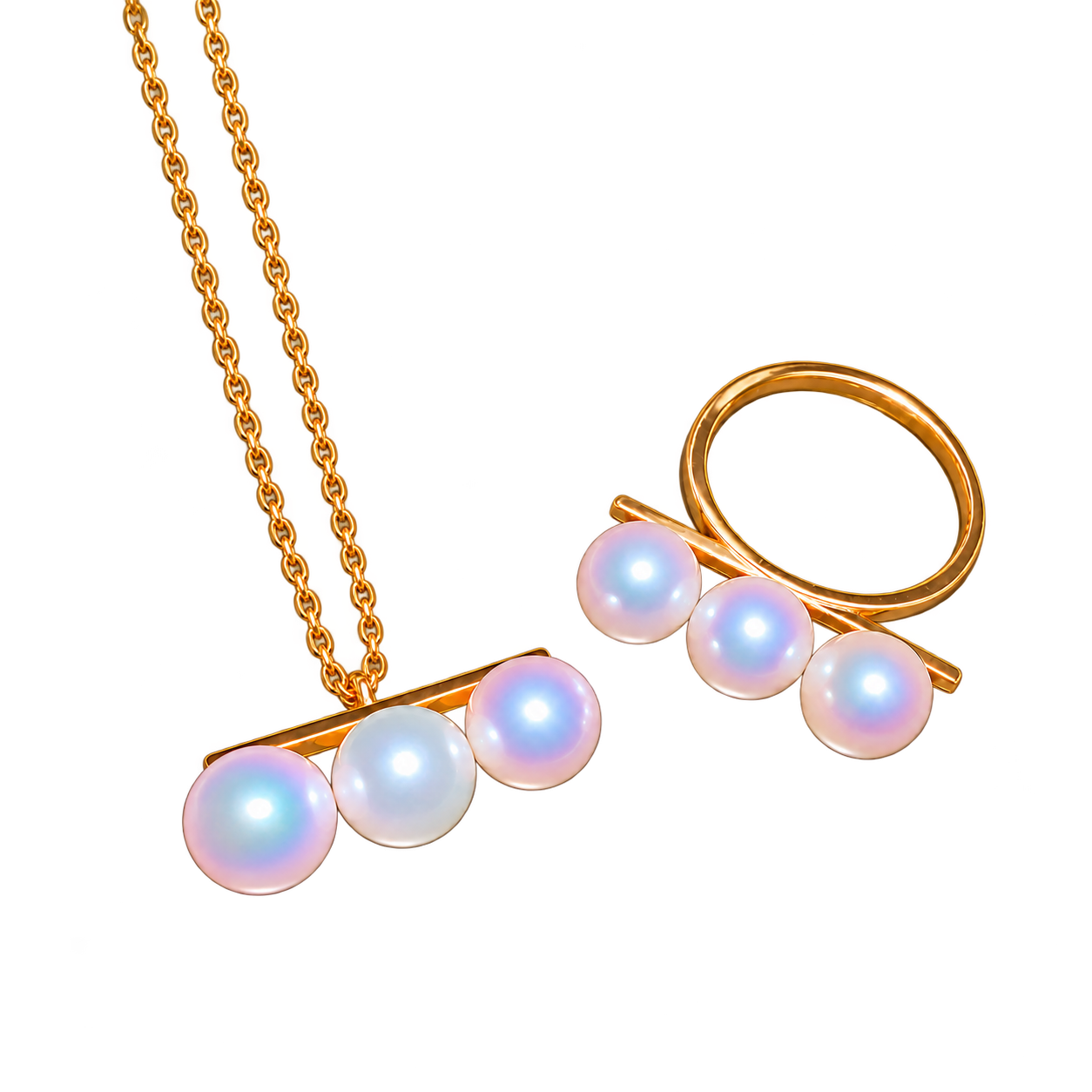 A pendant and ring, each with three white pearls