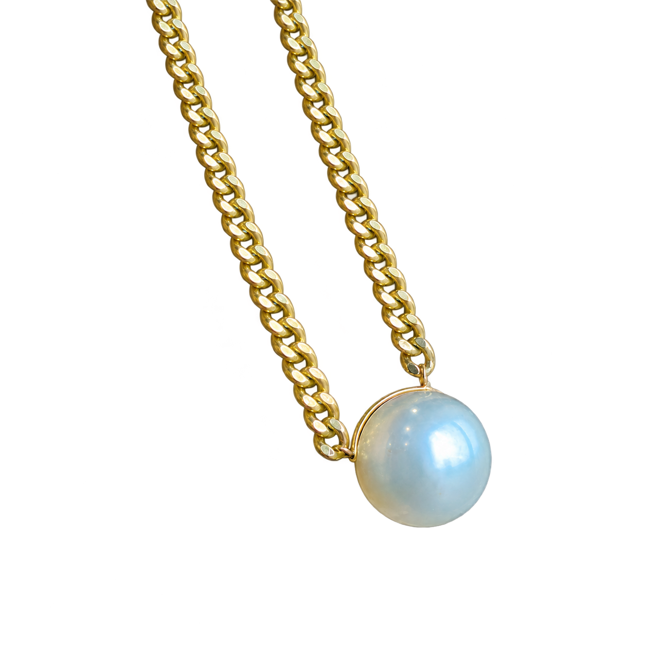 An Australian white pearl in a thin gold rim attached directly to a curb chain